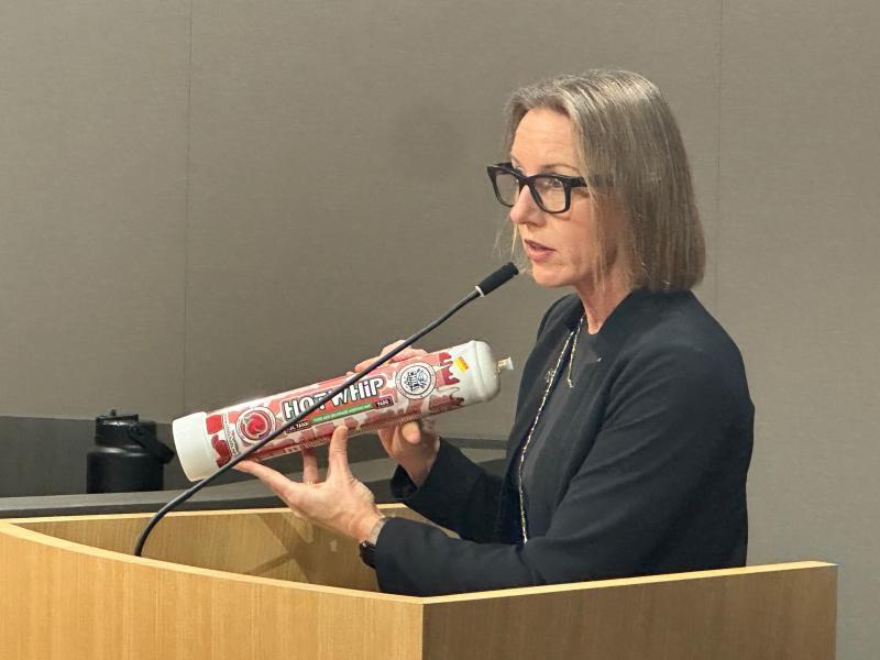 Sen. Blakespear displays a large canister of nitrous oxide